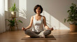 © mumtaz - Serene woman practicing yoga in a bright peaceful indoor space with potted plants and natural sunlight for relaxation mindfulness and wellness