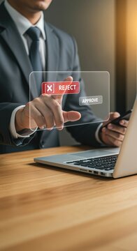 A business person using a laptop and a transparent screen with reject and approve options