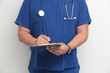 © Arlette - Dark-skinned Latino male specialist doctor reviews and writes patient reports on clipboard for record keeping and follow-up