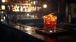 © AGIL - A vibrant cocktail at a dimly lit bar