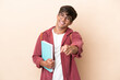 © luismolinero - Young student caucasian man isolated on ocher background pointing front with happy expression