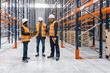 © Koldo_Studio - Warehouse workers and their manager are having a discussion about logistics and inventory inside a large distribution center