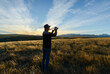 © Janice - Tourist taking photos at Peninsula Walkway, Lake Tekapo, South Island.