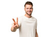 © luismolinero - Young blonde caucasian man over isolated background smiling and showing victory sign