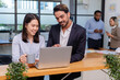 © PINA - team of multiethnic colleague discuss business topic in creative green office co working space, group of business people coworker casual online meeting on laptop standing desk modern office workplace
