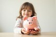 © Сергей Белый - Young child struggling to save money: holding empty piggy bank upside down.
