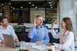 © ty - Business team celebrating success with high five in office.