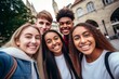 © nsit0108 - Group of cheerful young students taking a selfie in a european city during their vacation