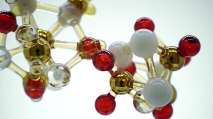 Poster - Detailed Molecular Structures of Gold White and Red Spheres Connected by Clear Rods on a Bright White Background