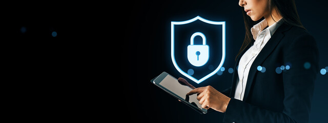 Fototapete - Businesswoman using tablet with glowing digital padlock shield symbol representing cybersecurity, data protection, and online privacy concept.