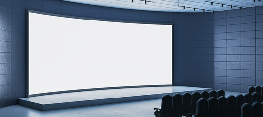 Poster - Curved white blank screen mockup on modern stage in empty dark auditorium with rows of black seats and tiled walls ready for business presentation. 3D Rendering
