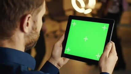 Businessman using tablet with green screen display for digital presentation close up view