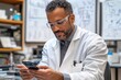 © isz - Research Scientist in Lab Using Smartphone for Data Analysis