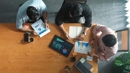 Poster - Executive manager explain financial graph to colleague at meeting room. Top aerial view of diverse marketing team sharing idea and planning strategy while sitting at table with tablet. Convocation.