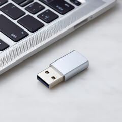 Poster - Modern Laptop Keyboard with Silver USB Flash Drive on White Marble Surface