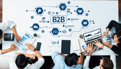 Poster - A dynamic business meeting where professionals collaborate on B2B e-commerce strategies using laptops and tablets to analyze data and develop effective sales agreements. Amity