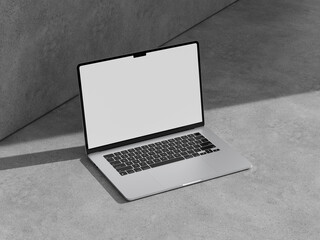 silver laptop on a soft gray cement background, showcasing a simple yet elegant workspace vibe.