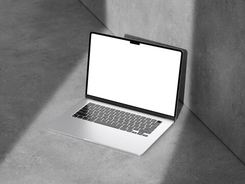 A well-lit laptop mockup on a cement surface, ideal for modern marketing and design projects.