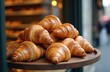 © Vadym - Golden brown croissants displayed on wooden tray outside Parisian bakery. Freshly baked buttery pastry, perfect breakfast or snack. Flaky layers, delicious baked goods, typical French cuisine item.