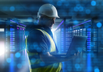 Poster - Man IT engineer. Worker standing in server room. Programmer engineer with laptop. Server center maintenance. Man in uniform inside telecommunication center. Specialist controls servers operation