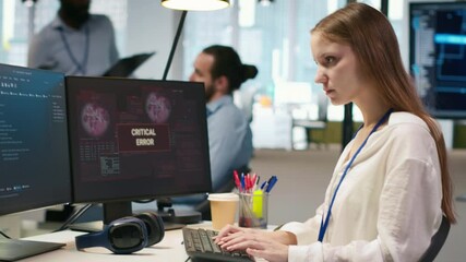 Poster - Female programmer in startup office struggling to fix application errors while coding. Young woman dealing with computer bugs while coding in software development agency, camera A