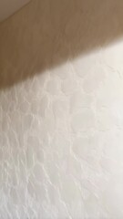 Poster - Neutral textured wall with subtle shadows creates a refined interior surface with an organic and handmade plaster effect in soft light