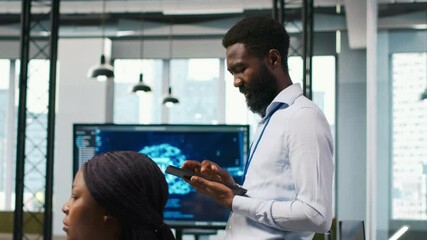 Fototapete - Joyous technician in office automating repetitive tasks using AI scripts. Upbeat man in workplace using artificial intelligence to speed up feature implementation, camera A