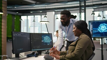 Poster - Happy engineers enjoying funny conversation at desk while using AI on computer to optimize performance. Cheerful colleagues in office chatting, training deep learning models using PC, camera A