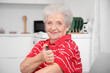 © Pixel-Shot - Diabetic senior woman using lancet pen in kitchen