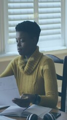Poster - Animation of data processing with numbers over african american businesswoman using laptop