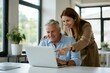 © 张锋 - Couple Collaborating on Laptop: A smiling couple, an older man and a younger woman, looking at a laptop together, with the woman pointing at the screen.
