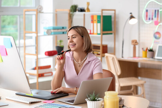 Female web designer working at table in office