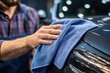 © Vlad - Car Towel: Man Detailing Auto with Blue Microfiber Cloth for a Spotless Clean Finish
