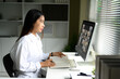 © Prathankarnpap - Side view of woman in white shirt joining a financial webinar or virtual team meeting