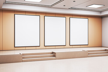 Poster - Three vertical blank posters on modern indoor stage wall in empty exhibition room with clean light interior and beige panel background. 3D Rendering