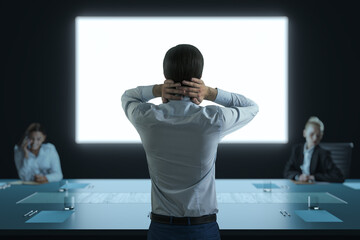 Poster - Businessman seen from back standing in conference room during office meeting with large screen display in background, facing businesspeople.