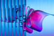 © Westend61 - Abstract 3D glass design with pink and blue fluted ribbons and reflections