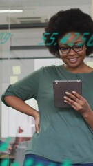 Leinwandbilder - Animation of graph, globe and changing numbers over african american woman using digital tablet