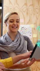 Poster - Two business executives are discussing over a digital tablet in their office