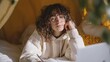 © Viktoriia - Relaxed young woman in cozy bedroom with notebook and glasses