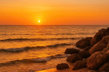 Poster - Sunset over rugged shoreline with vibrant orange sky and calm ocean backdrop