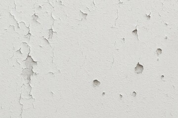 Poster - The deteriorating white cement walls show peeling paint and multiple holes.