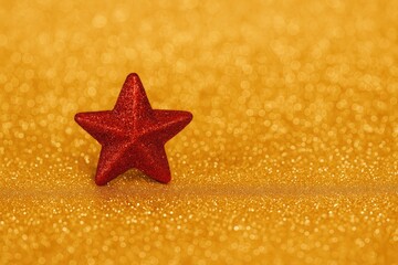 Poster - Festive red star ornament on sparkling background for holiday celebrations