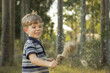 © Austockphoto - Young boy waving a bulrush seed head in the wind
