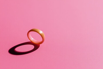 Aufkleber - Single onion ring casting shadow on smooth pink background minimal style vibrant color food concept copy space snack round shape playful mood isolated object