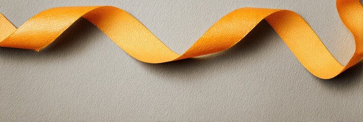 Poster - Floating Orange Zest Ribbon Gracefully Placed on a Subtle Matte Background, Creating an Eye-Catching Visual Appeal