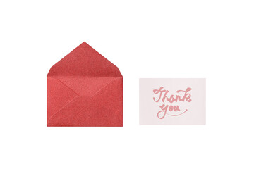 Wall Mural - overhead view of a cutout of a red lamé envelope with a pink handwritten thank-you card placed next 