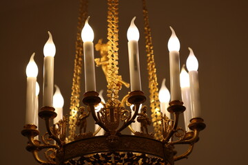 Aufkleber - A beautiful chandelier with many lit candles inside