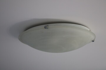 Poster - A single ceiling light mounted on a white wall, ideal for use in minimalist interior design or as a decorative element