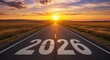 © Cleverson - Road to 2026: A long, paved road stretches towards a bright sunrise, symbolizing a journey or goal ahead in time.